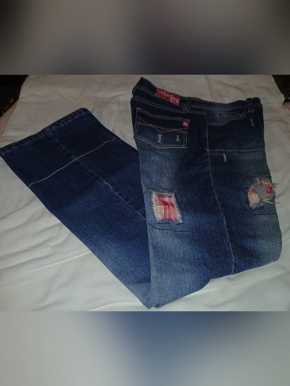 Pre-loved Women's Dark Blue Distressed Jeans with Plaid Patch Detail.